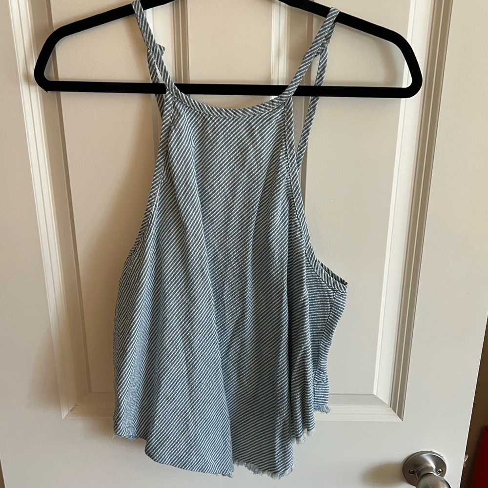 Women’s high neck tank with cute back detailing.